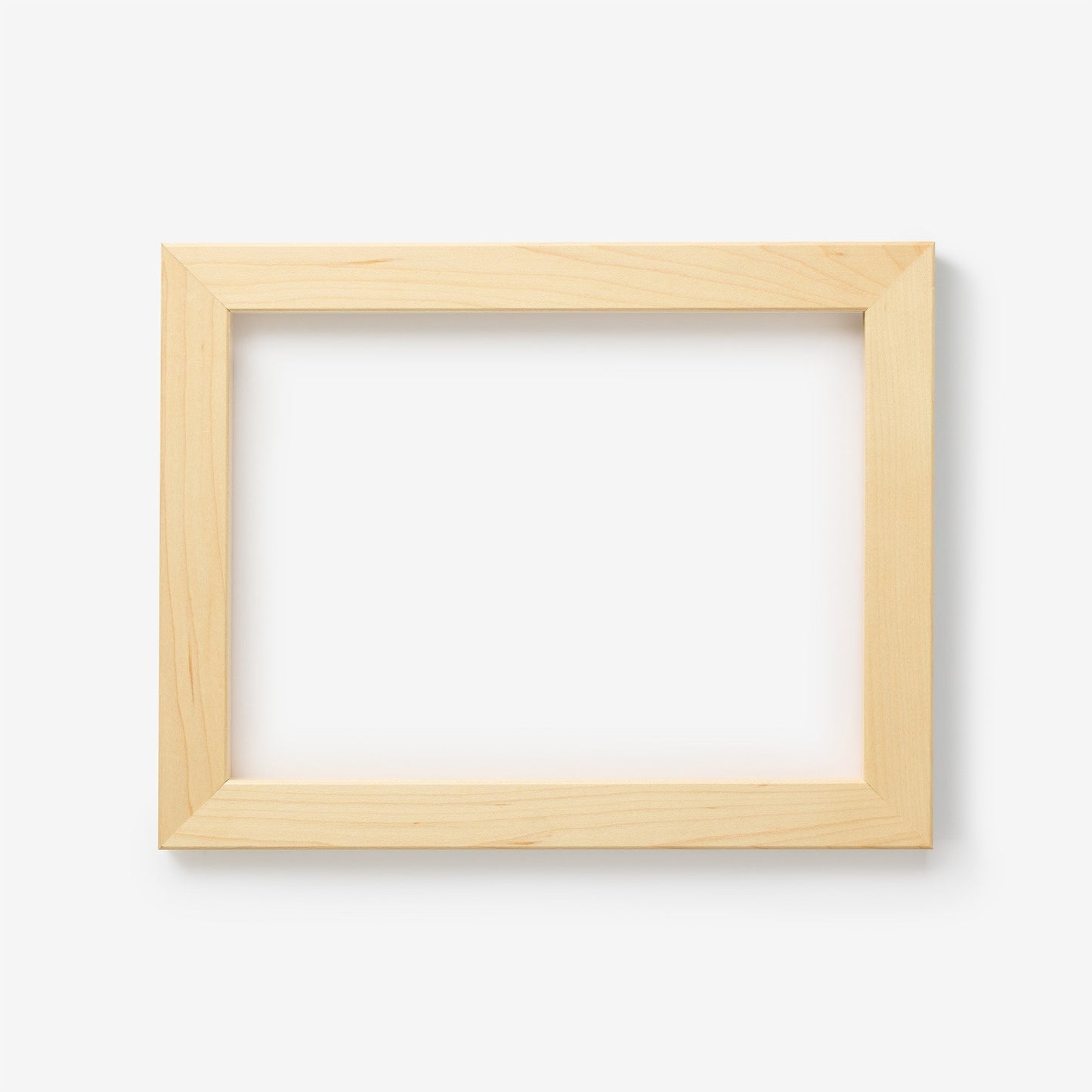 A small rectangular maple wood frame on a white background