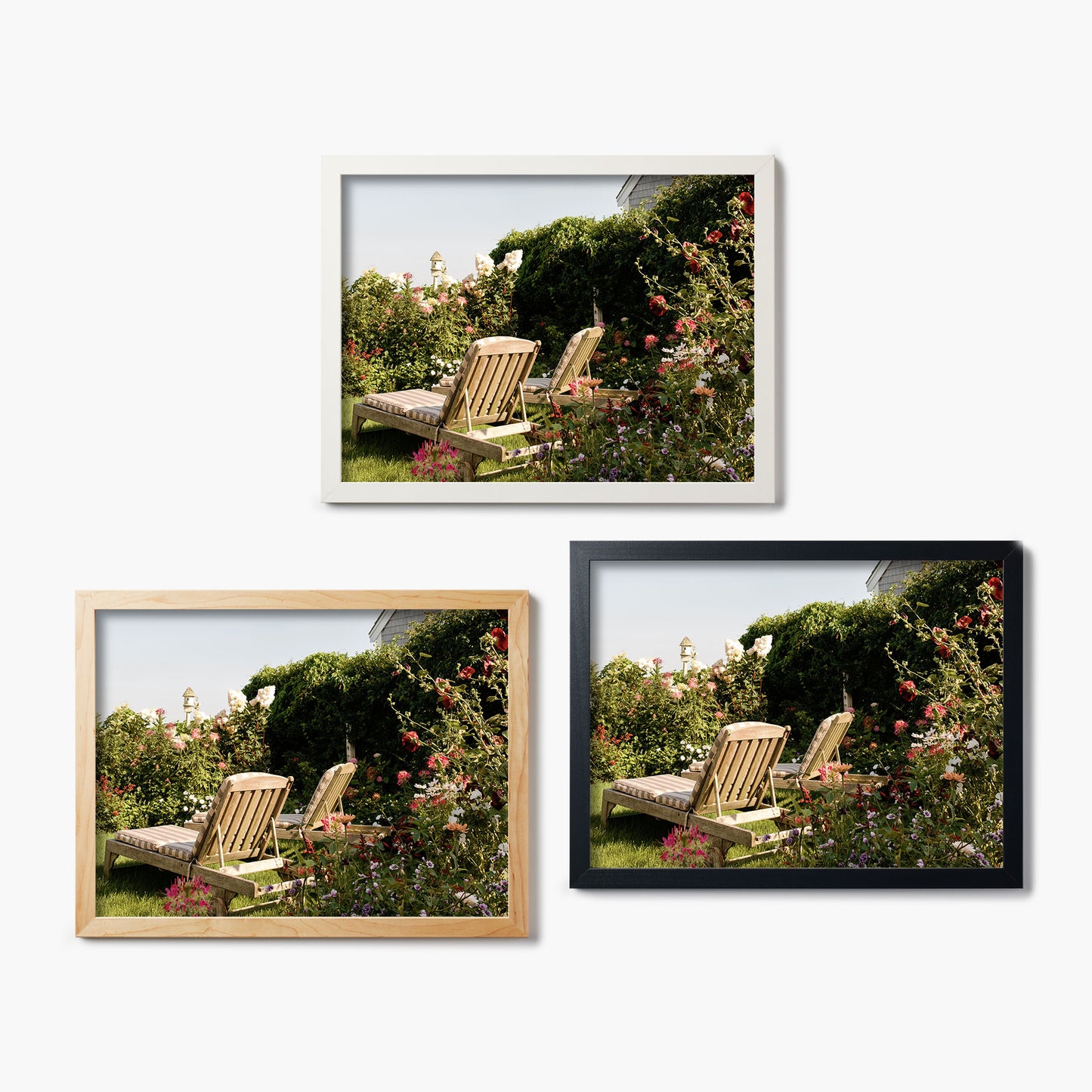 Three framed glass prints of a garden scene with chairs and flowers on a white background.