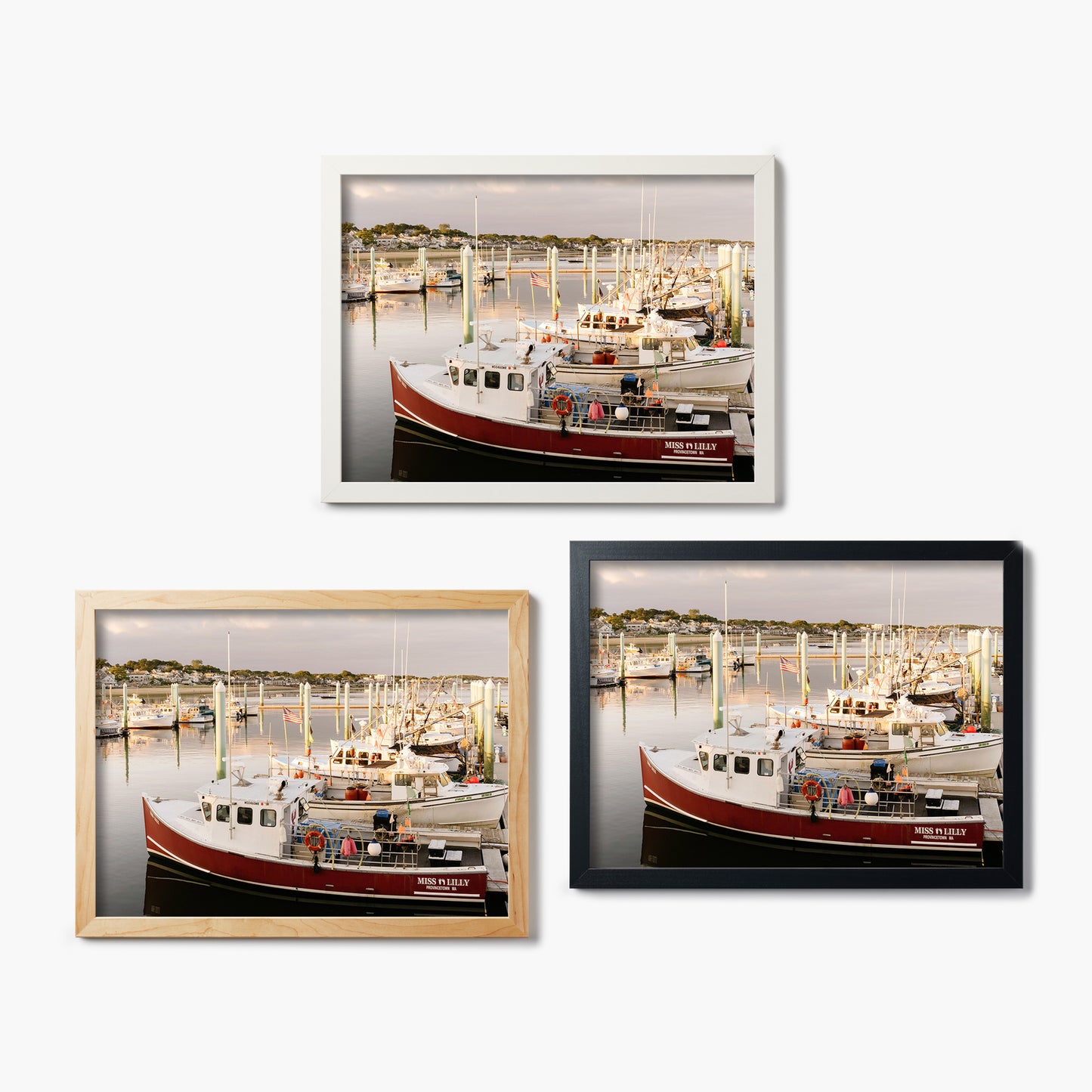 Three framed glass prints of a boat docked at a marina on a white background