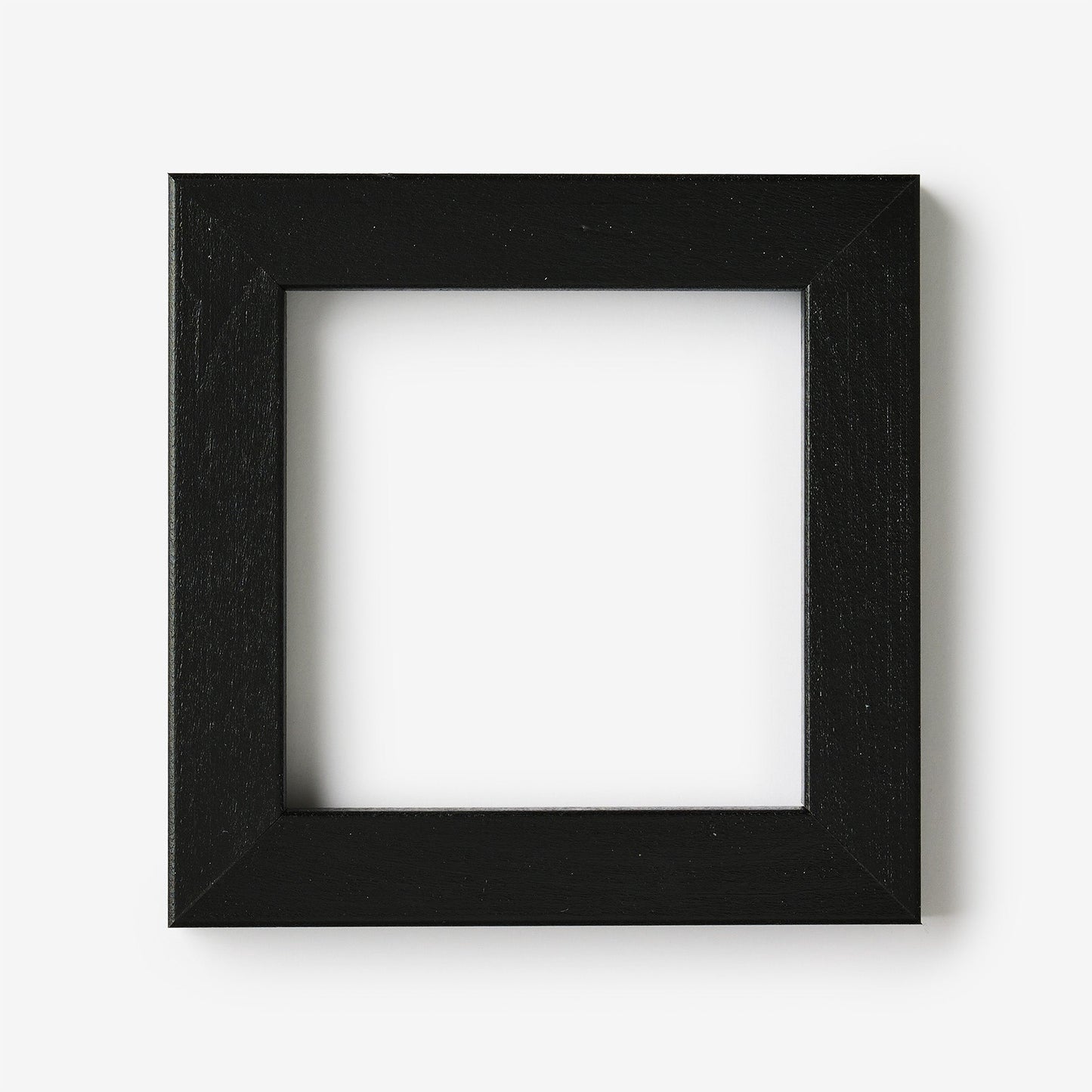 A small square black wood frame on a white background