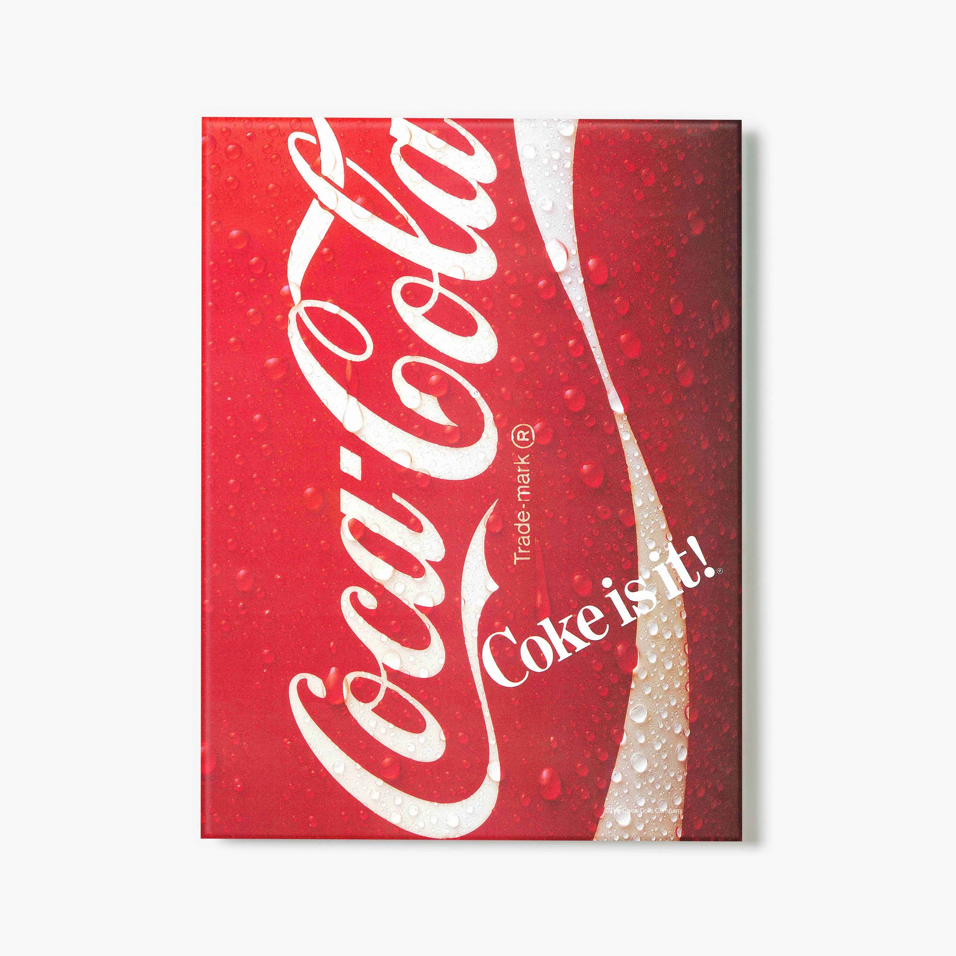 Glass print of Coca-Cola logo on a red can background with 'Coke is it!' text