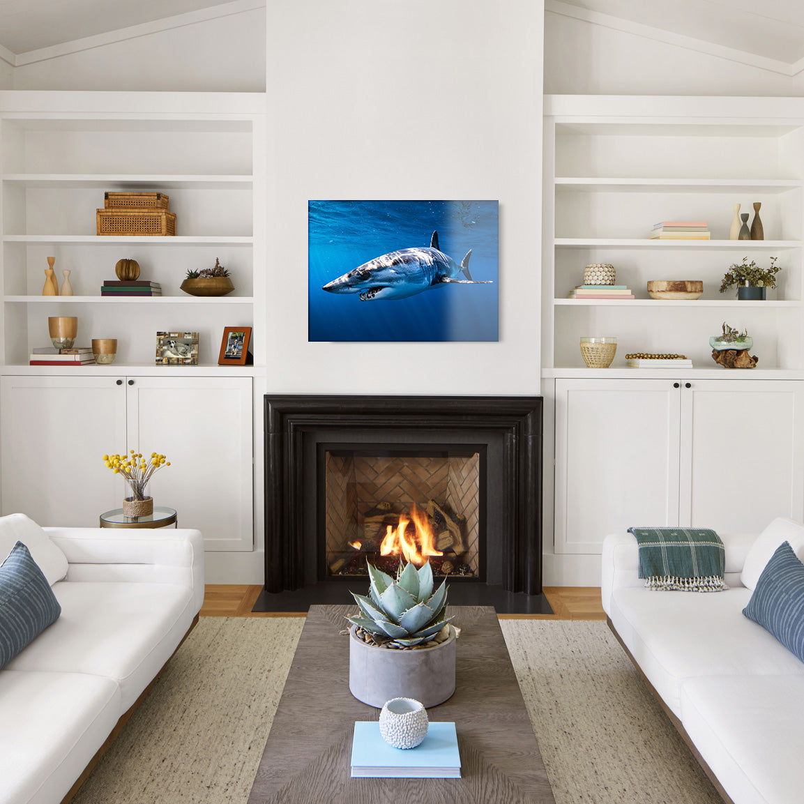Living room with a shark glass print as the centerpiece on the wall above a fireplace